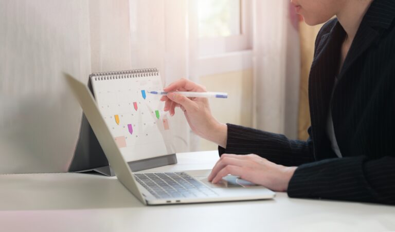woman writing on a calendar