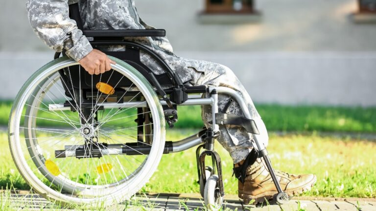 Young soldier in wheelchair outdoors